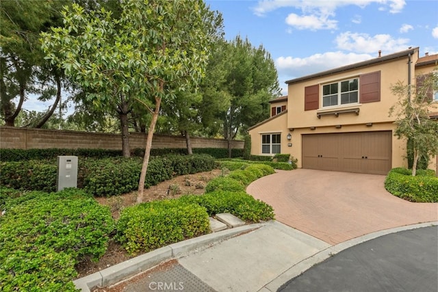 21 Deergrass, Irvine, CA 92618 - view of front of house featuring a garage, decorative driveway, and stucco siding