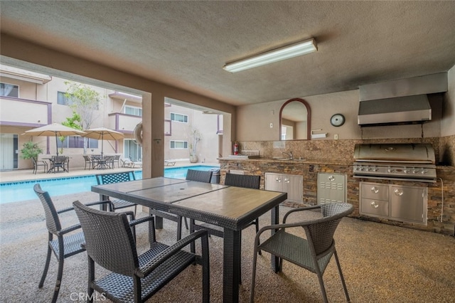 dining area featuring carpet floors and a textured ceiling