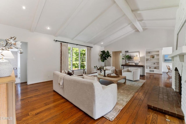 living room with hardwood / wood-style floors, vaulted ceiling with beams, and a fireplace