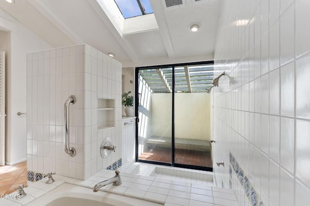 full bathroom with beamed ceiling, a sink, tub / shower combination, tile patterned floors, and a skylight