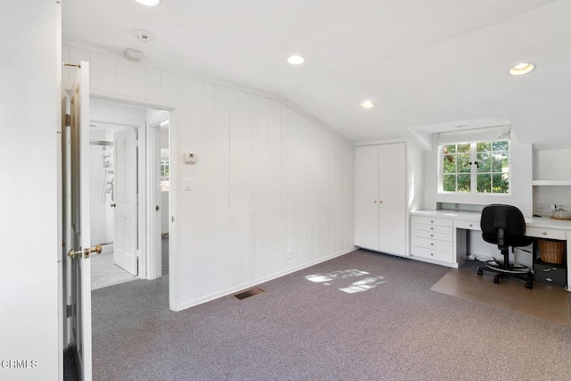 office featuring dark carpet, visible vents, built in study area, recessed lighting, and vaulted ceiling