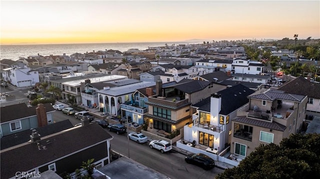 drone / aerial view featuring a water view and a residential view
