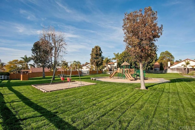 community play area with fence and a lawn