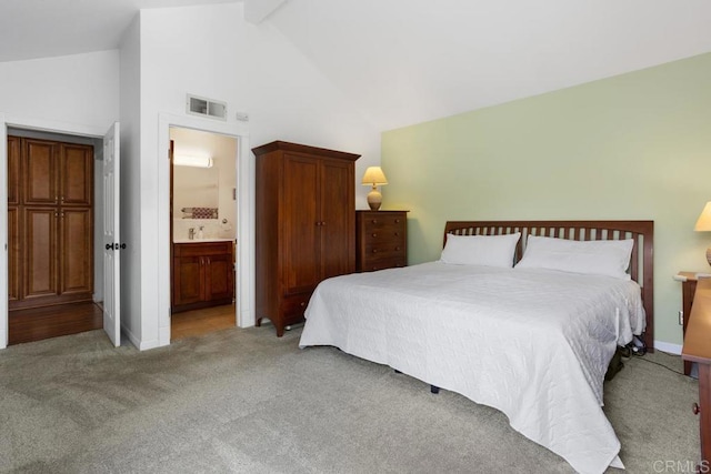 bedroom with a sink, light colored carpet, visible vents, ensuite bathroom, and high vaulted ceiling
