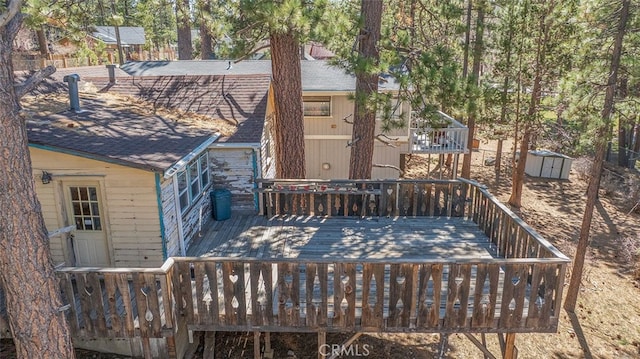 deck with an outbuilding and a storage shed