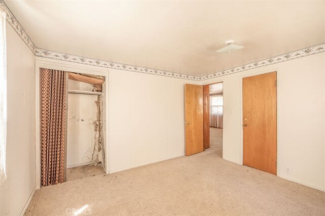 unfurnished bedroom with a closet and carpet