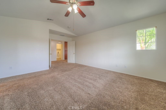 unfurnished room with light carpet, vaulted ceiling, visible vents, baseboards, and a ceiling fan
