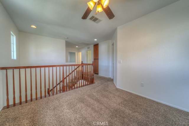 carpeted spare room featuring baseboards, a ceiling fan, visible vents, and recessed lighting