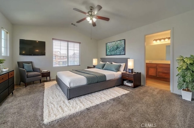 carpeted bedroom featuring connected bathroom, lofted ceiling, multiple windows, and visible vents