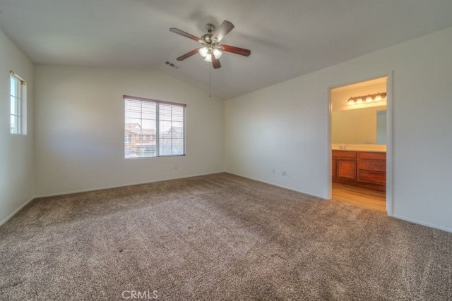 unfurnished bedroom with light carpet, vaulted ceiling, visible vents, and multiple windows