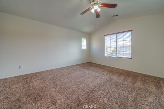 carpeted spare room featuring ceiling fan, lofted ceiling, visible vents, and baseboards