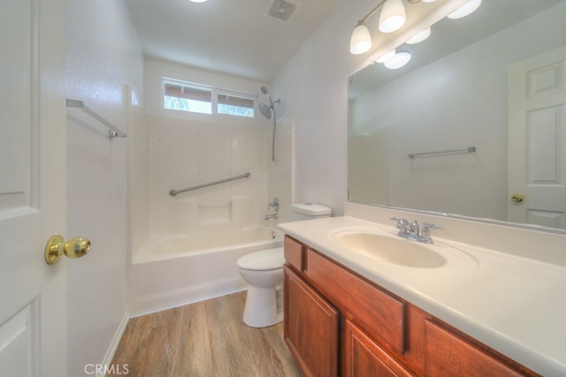 full bathroom featuring toilet, visible vents, shower / bath combination, wood finished floors, and vanity