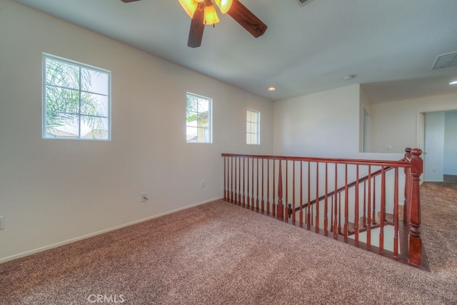 carpeted spare room with baseboards, a ceiling fan, visible vents, and recessed lighting
