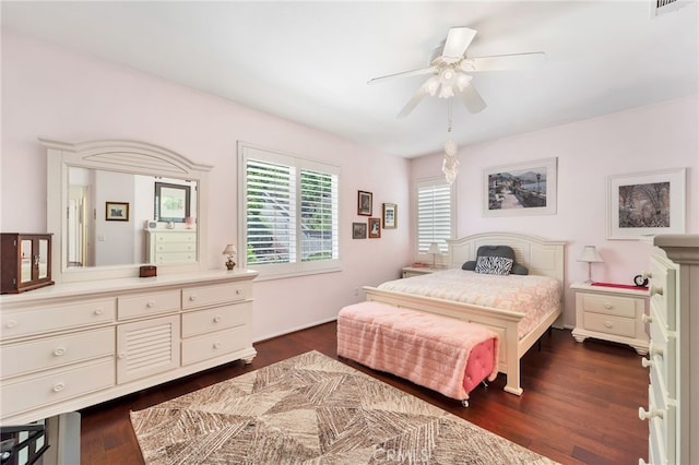 bedroom featuring a ceiling fan, dark wood finished floors, and visible vents