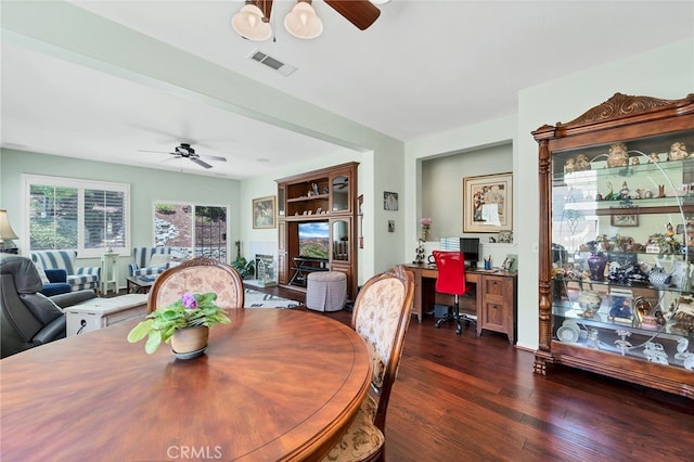 dining area with a ceiling fan, dark wood-style floors, and visible vents