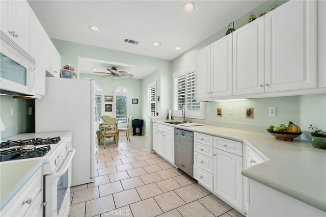 kitchen with visible vents, white appliances, ceiling fan, white cabinetry, and a sink