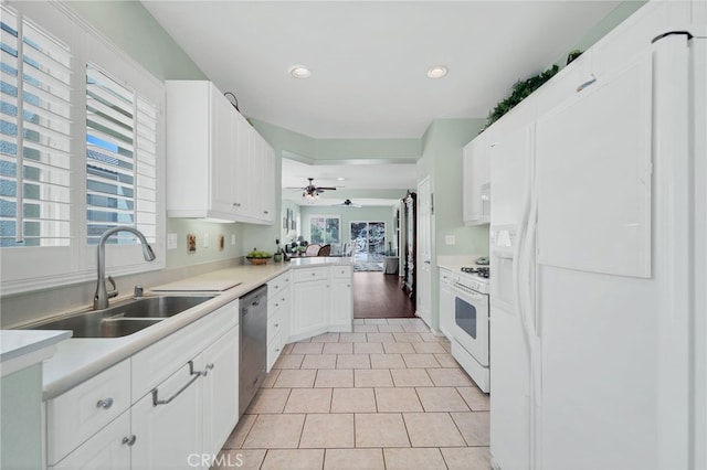 kitchen featuring a sink, recessed lighting, white appliances, and a healthy amount of sunlight