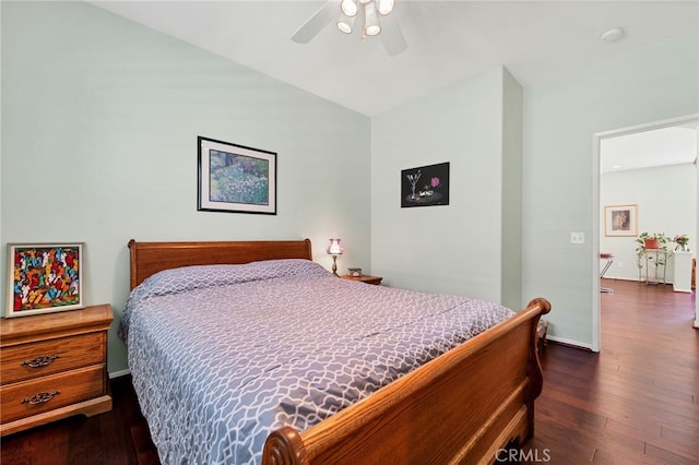 bedroom with dark wood-type flooring, a ceiling fan, and baseboards