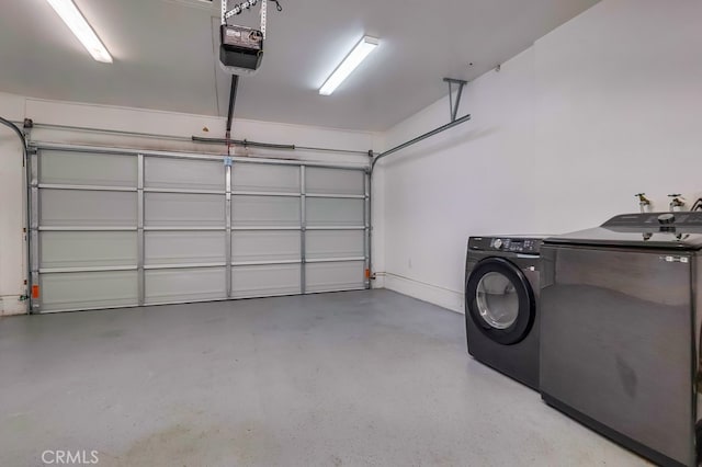 garage featuring washing machine and clothes dryer and a garage door opener