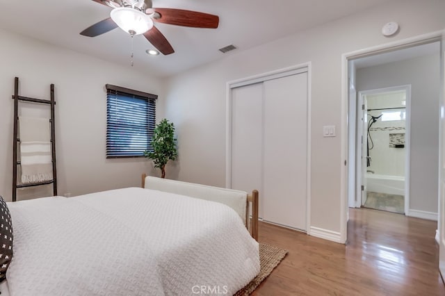 bedroom with baseboards, a closet, visible vents, and light wood-style flooring