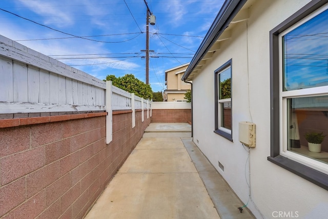 view of property exterior with a patio area, a fenced backyard, and stucco siding