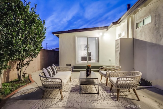 view of patio featuring fence, an outdoor hangout area, and visible vents