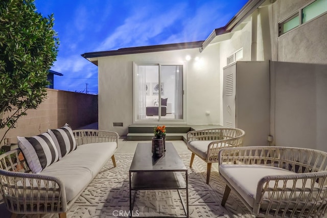 view of patio with outdoor lounge area and fence