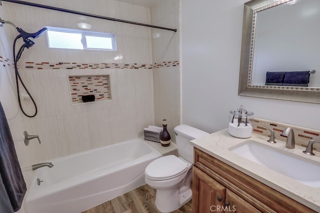 bathroom with toilet, wood finished floors, vanity, and tub / shower combination