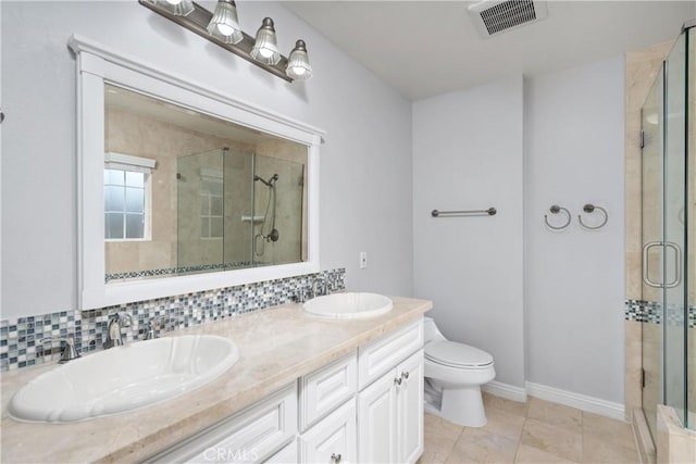 bathroom featuring visible vents, a sink, toilet, and a shower stall