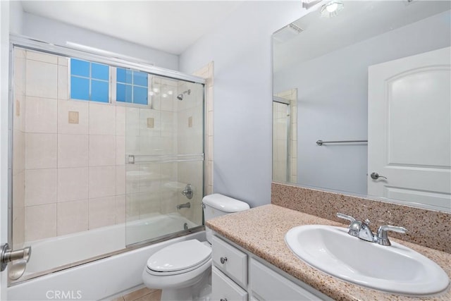 bathroom with vanity, bath / shower combo with glass door, and toilet