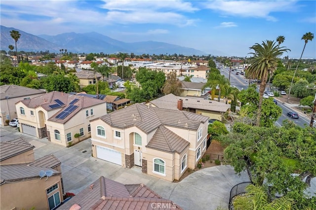 drone / aerial view featuring a residential view and a mountain view