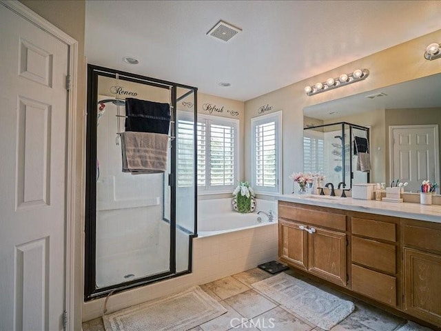 37192 Amateur Way, Beaumont, CA 92223 - bathroom with tile patterned floors, visible vents, a shower stall, a garden tub, and vanity