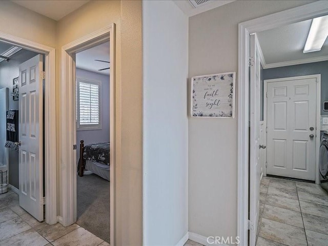 37192 Amateur Way, Beaumont, CA 92223 - corridor featuring baseboards, stacked washer / dryer, and ornamental molding