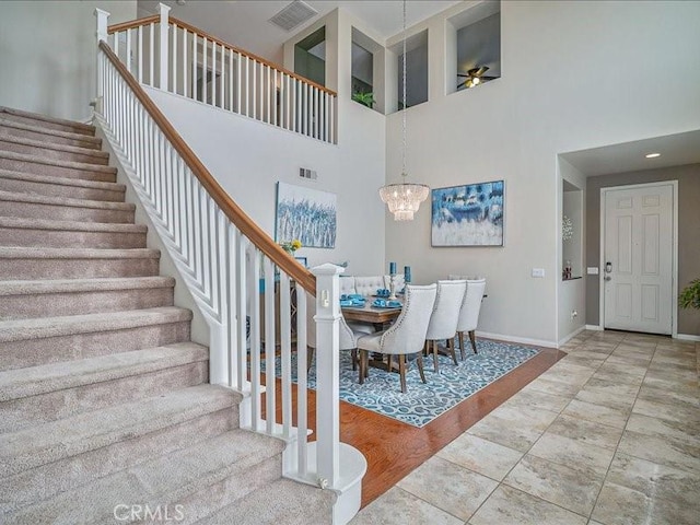 37192 Amateur Way, Beaumont, CA 92223 - stairway featuring visible vents, baseboards, a high ceiling, and a chandelier