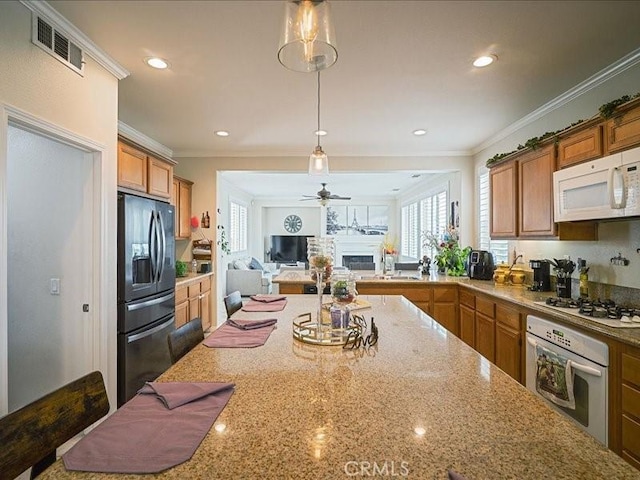 37192 Amateur Way, Beaumont, CA 92223 - kitchen featuring brown cabinetry, visible vents, plenty of natural light, and white appliances