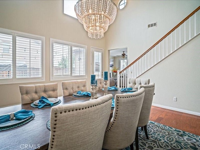 37192 Amateur Way, Beaumont, CA 92223 - dining space featuring baseboards, visible vents, a chandelier, wood finished floors, and a high ceiling