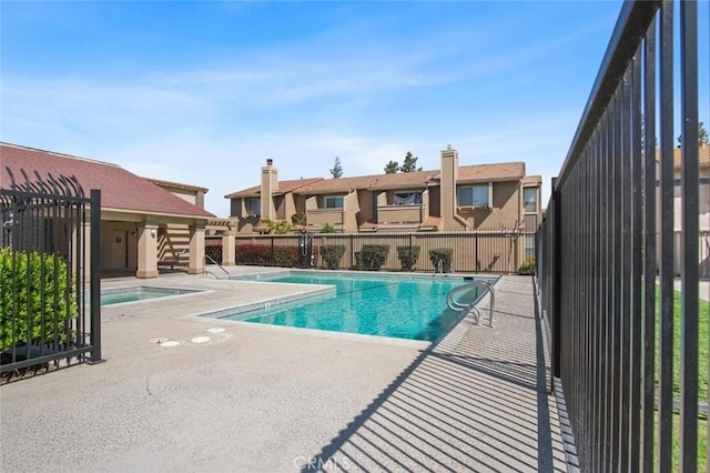 pool featuring fence and a patio