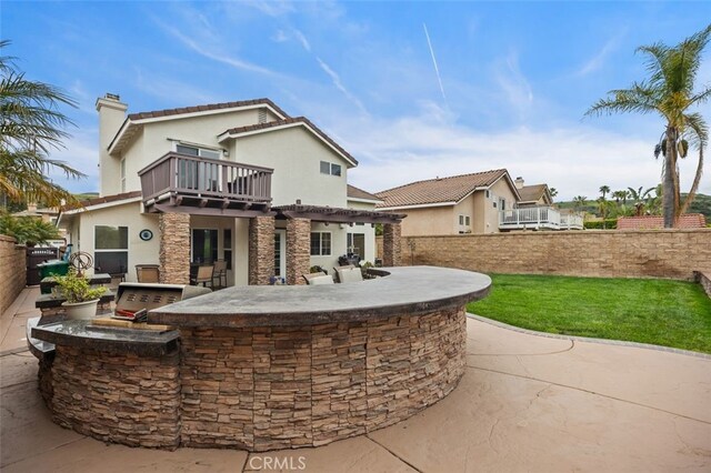 4 Chisholm Trl, Trabuco Canyon, CA 92679 - back of house with an outdoor kitchen, an outdoor bar, a chimney, a balcony, and stone siding