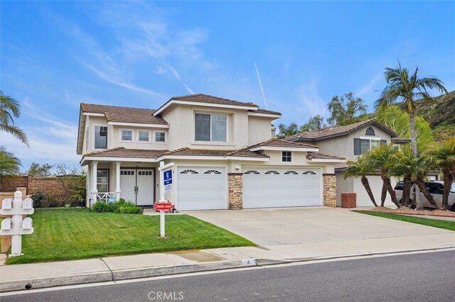 4 Chisholm Trl, Trabuco Canyon, CA 92679 - view of front of home featuring stucco siding, a garage, driveway, stone siding, and a tiled roof