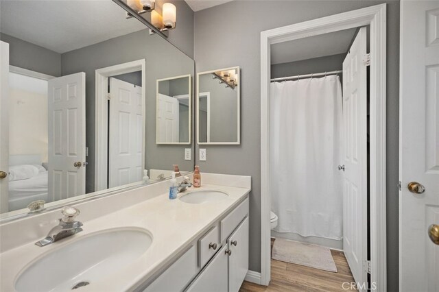 4 Chisholm Trl, Trabuco Canyon, CA 92679 - full bathroom featuring wood finished floors, toilet, double vanity, and a shower with curtain