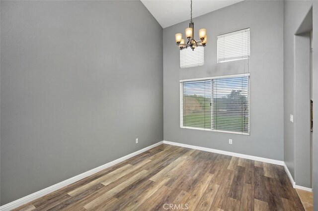 4 Chisholm Trl, Trabuco Canyon, CA 92679 - spare room with a chandelier, wood finished floors, baseboards, and vaulted ceiling
