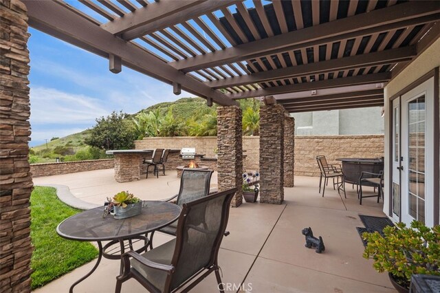 4 Chisholm Trl, Trabuco Canyon, CA 92679 - view of patio featuring outdoor dining area, a pergola, fence, and a mountain view