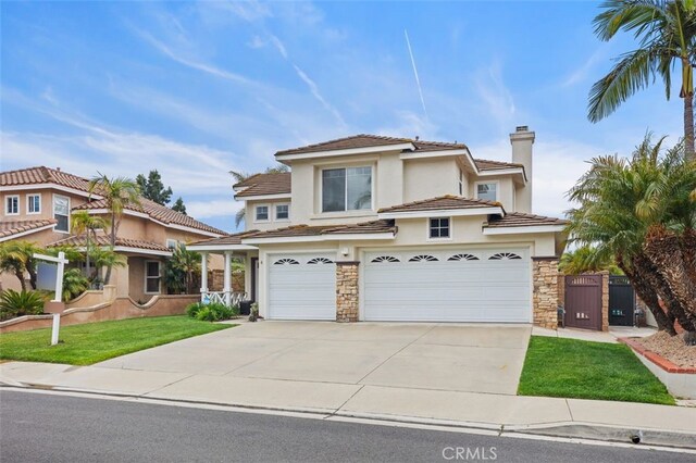 4 Chisholm Trl, Trabuco Canyon, CA 92679 - view of front of property with a garage, stone siding, concrete driveway, and stucco siding