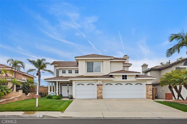 4 Chisholm Trl, Trabuco Canyon, CA 92679 - view of front of property featuring concrete driveway, stucco siding, stone siding, and a garage