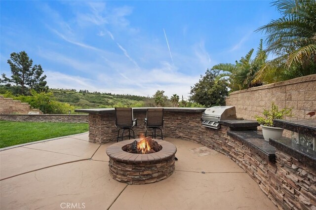 4 Chisholm Trl, Trabuco Canyon, CA 92679 - view of patio / terrace with area for grilling, exterior kitchen, a fire pit, and a bar