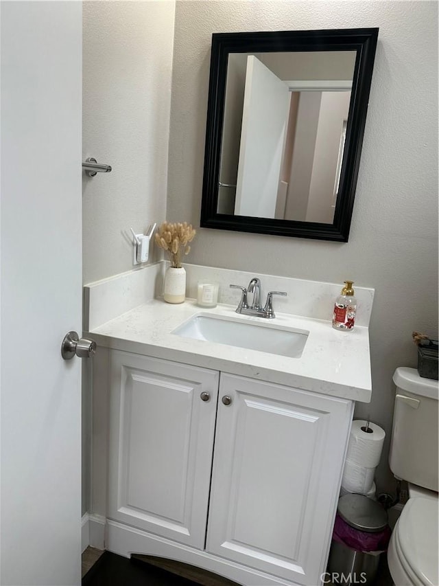 bathroom with toilet and vanity