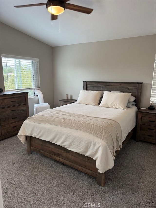 carpeted bedroom featuring vaulted ceiling and ceiling fan