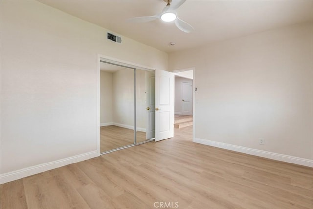 unfurnished bedroom with visible vents, a ceiling fan, light wood-type flooring, a closet, and baseboards