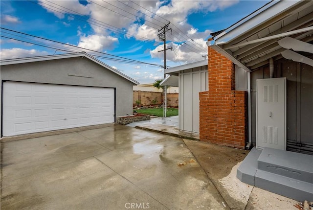 detached garage featuring fence