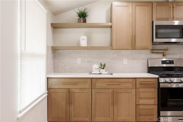 kitchen featuring open shelves, decorative backsplash, light countertops, lofted ceiling, and appliances with stainless steel finishes